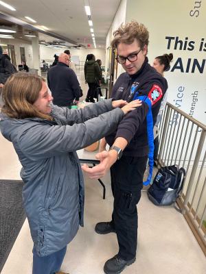 Student EMS worker showing how a blood pressure cuff works
