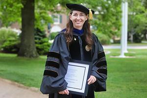 Professor Tauna Sisco, Ph.D. stands with her award.