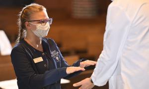 Student receiving blessing of the hands