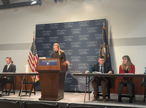 NHIOP Ambassador Kathryn Monahan addresses the audience as she advocates for the Negative during the debate.