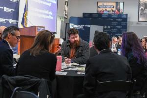 People discussing housing at a roundtable event