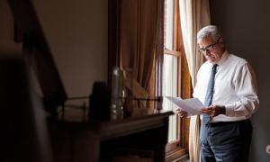 President Favazza studies a paper in his office