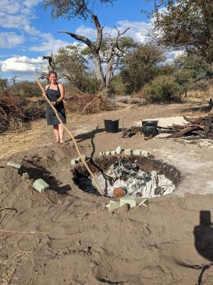 Kersey-Asbury tends to the pit fire in the Moela Safari camp.