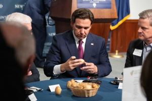 Ron DeSantis signing an egg