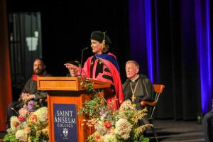 Emily Orlando giving a speech in the Koonz Theater for the convocation ceremony