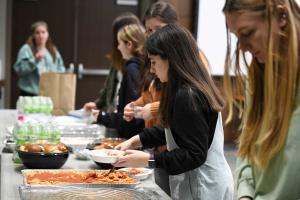 Students eating from a selection of foods commonly found in impoverished households