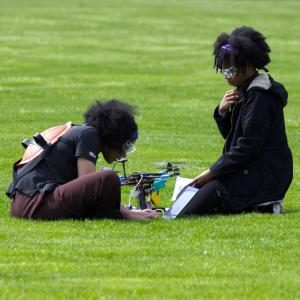 Two students calibrating a drone