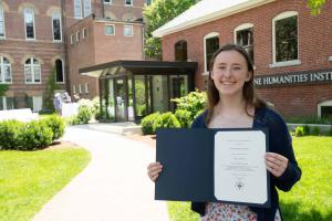 Mary Markounas ’26 holding up her Grappone Fellowship award