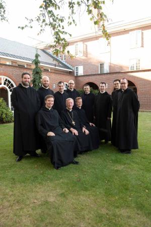 Abbot Mark Cooper, O.S.B. ’71 sits with a group of younger members of the monastery