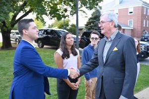 Student shaking hands with a governor participating in the Braver Angels program