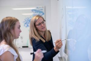 Professor teaching a student in the classroom