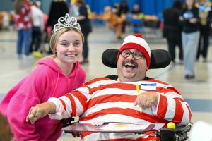 A student volunteer with a guest at the Meelia Center's Halloween Party