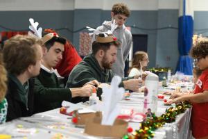 Student volunteers participated in the Holiday Fair by making crafts with the local children