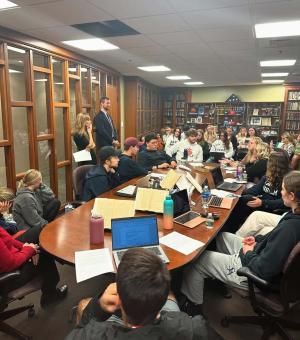 Students and faculty gathered for the "God Behind Bars" event in the NHIOP Political Library