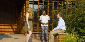 students chat in front of the NHIOP