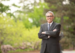 Dr. Favazza smiles for the camera, arms folded in front