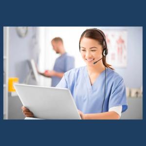 Nurse with a headset on smiling at a computer
