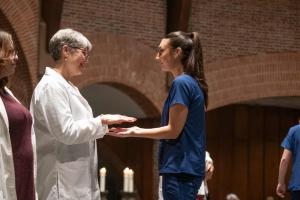 Nursing student having their hands blessed during the Blessing of the Hands Ceremony