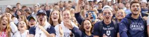 Students cheering in the stands of Grappone Stadium