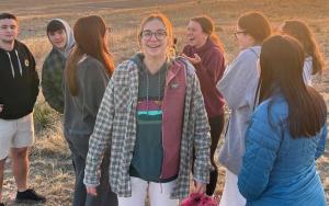 Students in a retreat group standing on a beach