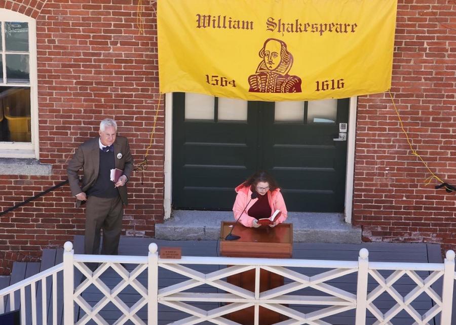 Student reads at podium outside