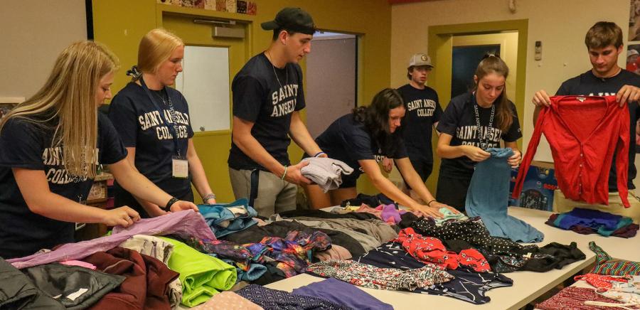 Students sort clothes for charity on their day of service