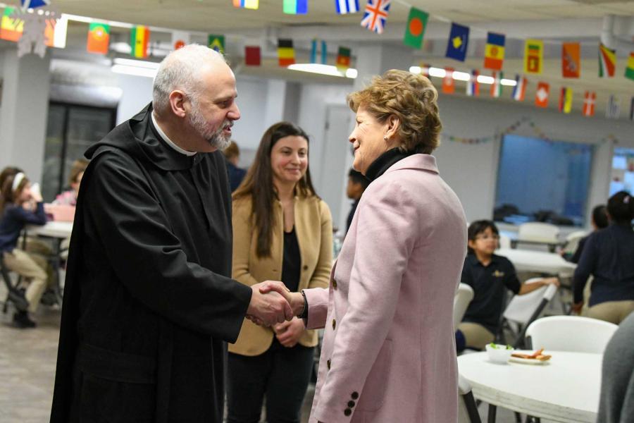 Senator Shaheen shaking hands with a monk