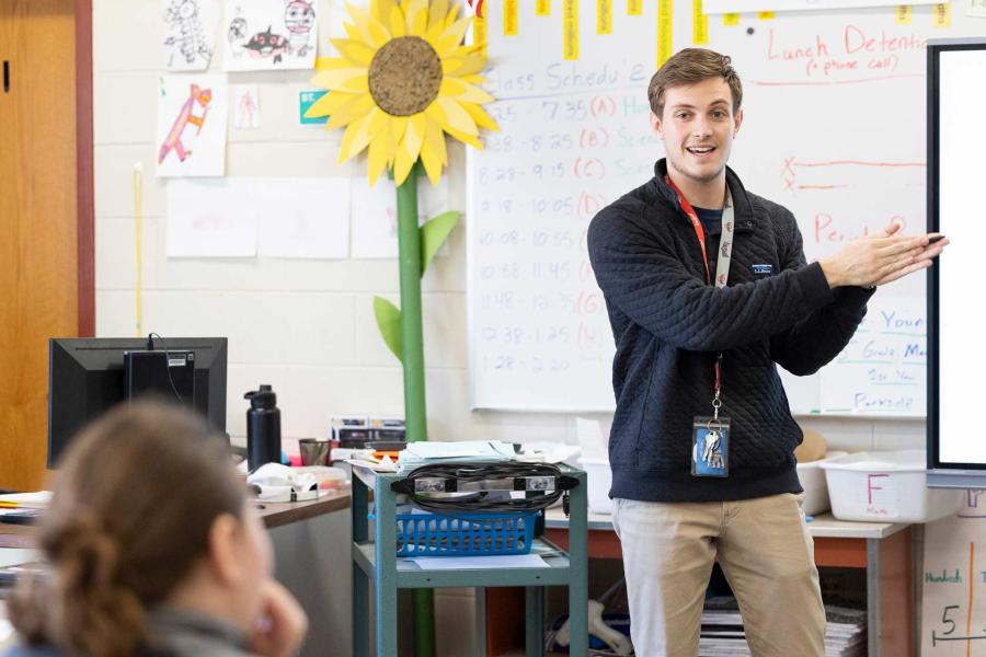 Graduate working in a classroom with children