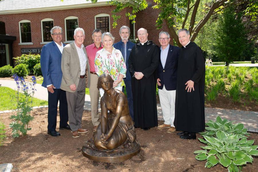 Members of the College gather for the dedication of the Joan of Arc statue