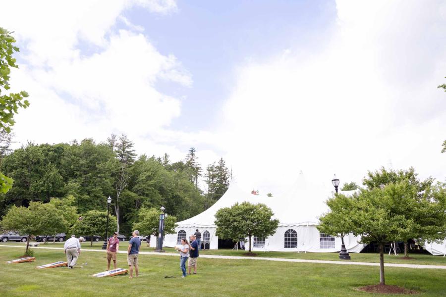 A view of the tent and cornhole boards on the lower quad